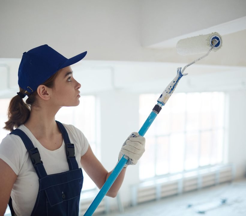 Restoring ceiling House painter renovating ceiling with whitewash